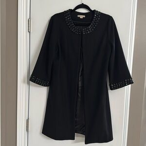 Beautiful knee length coat with 3/4 length sleeves.